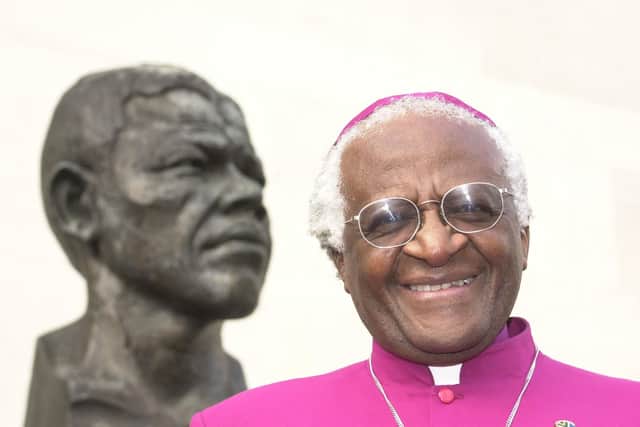 File photo dated 27/05/01 of Desmond Tutu standing next to a bust of former South African president Nelson Mandela. Desmond Tutu, the Nobel Peace Prize-winning activist for racial justice and LGBT rights, has died aged 90. He had been treated in hospital several times since 2015, after being diagnosed with prostate cancer in 1997.