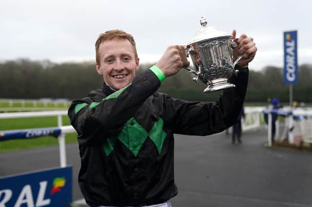 Jockey Stan Sheppard celebrates with the trophy after winning the Coral Welsh Grand National Handicap Chase on Iwilldoit during Coral Welsh Grand National Day at Chepstow Racecourse.