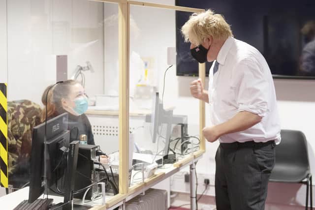 What will 2022 mean for Boris Johnson in the wake of myriad controversies? He is pictured on Wednesday at a Covid vaccine centre in Milton Keynes.