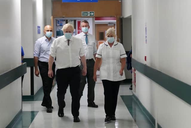 Prime Minister Boris Johnson and Health Secretary Sajid Javid (left) speak with staff and patients during a visit to Leeds General Infirmary prior to the Tory party conference in Manchester in early October.