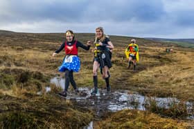 Runners in superhero costumes