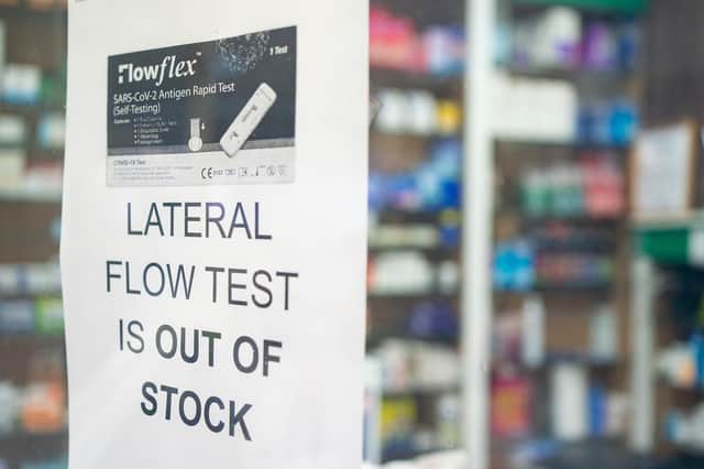 A sign saying lateral flow coronavirus tests are out of stock is seen at a pharmacists in London.
