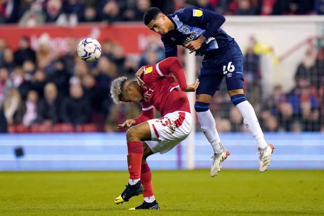 Aerial battle: Nottingham Forest's Lyle Taylor (left) and Huddersfield Town's Levi Colwill tangle. Picture: Tim Goode/PA Wire.