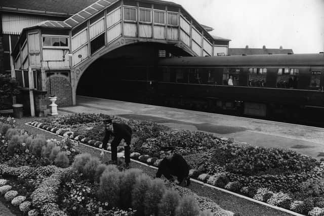David Pexton, left, (ticket collector) and Mr. John Jefferson (porter) working on the flower beds at Beverley Station in 1964