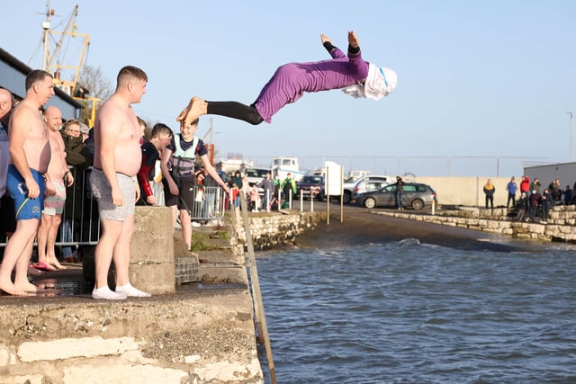 Leaping into 2022 at the annual New Year's Day swim in Carnlough. Pic Pacemaker