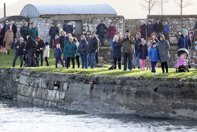 Spectators watch the swimmers at the annual New Year's Day swim in Carnlough, Co Antrim. The event celebrated its 50th anniversary this year.
Picture by Stephen Davison