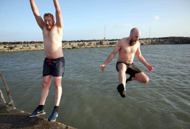 Adam Neill and Nathan McCall make a splash in the New Year's Day swim in Carnlough. Picture: Stephen Davison / Pacemaker.