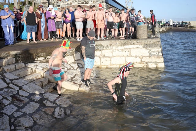 The annual New Year's Day swim in Carnlough celebrated its 50th anniversary with Geoff Bell, who has taken part in everyone of the previous 49 events, leading the swimmers into the icy cold water.
 Picture: Stephen Davison / Pacemaker.