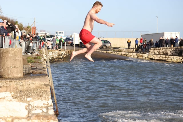 Leaping into 2022 at the annual New Year's Day swim in Carnlough, Co. Antrim.
Picture: Stephen Davison.