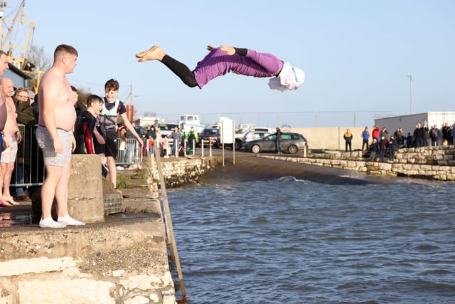 Diving into Carnlough harbour during the New Year's Day swim. Picture: Stephen Davison / Pacemaker.