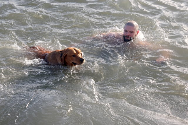 This man and his dog enjoyed the annual New Year's Day swim in Carnlough, Co. Antrim.  Picture: Stephen Davison / Pacemaker.