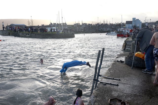 Leaping into 2022 at the New Year's Day charity swim in Carnlough, Co. Antrim. Picture: Stephen Davison / Pacemaker.
