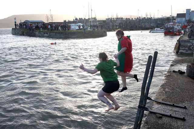 Taking part in the charity swim at Carnlough harbour.  Picture: Stephen Davison / Pacemaker.