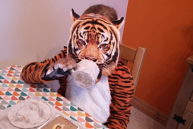 The Tiger who went to tea enjoying some tea and cake.