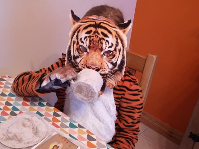 The Tiger who went to tea enjoying some tea and cake.