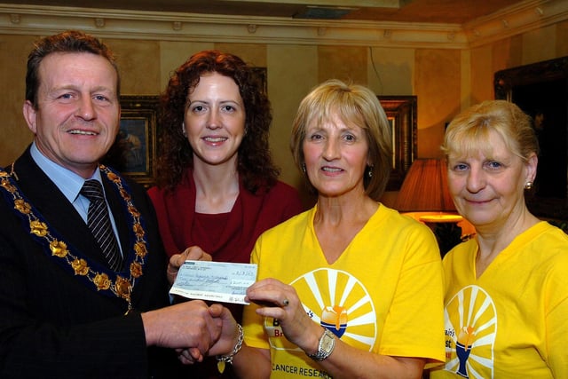 Ian Milne, Magherafelt District Council chairman, hands over a cheque to Maghera Cancer Research NI committee chairperson Violet Philips at the successful  Big Breakfast event in aid of Cancer Research NI. Included in the picture are Kate Lagan (Vice-Chairperson) and Glenda Milligan (Cancer Research Community fundraiser).