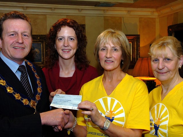 Ian Milne, Magherafelt District Council chairman, hands over a cheque to Maghera Cancer Research NI committee chairperson Violet Philips at the successful Big Breakfast event in aid of Cancer Research NI. Included in the picture are Kate Lagan (Vice-Chairperson) and Glenda Milligan (Cancer Research Community fundraiser).