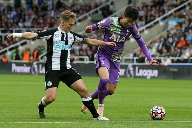 Heung-Min Son of Tottenham Hotspur is challenged by Matt Ritchie of Newcastle United during the Premier League match between Newcastle United and Tottenham Hotspur at St. James Park on October 17, 2021 in Newcastle upon Tyne, England.