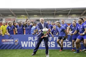 Carl Hall lifts the League 1 promotion trophy aloft. (Photo: Allan McKenzie/SWpix.com)
