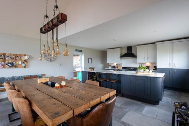 The kitchen and bespoke table in the open plan living/sitting/dining area