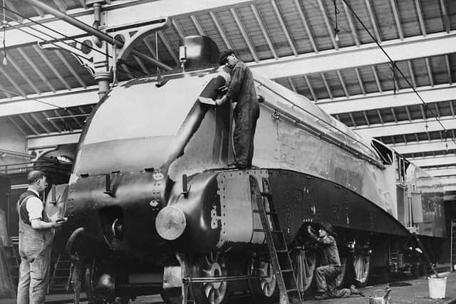 The LMS ( London Midland and Scottish Railway) Sir Nigel Gresley designed Jubilee Class 5552 Silver Jubilee 4-6-0 express steam locomotive with A4-style streamlining being painted at the Doncaster railway works on 31 October 1935  in Doncaster, United Kingdom.  (Photo by Harry Todd/Fox Photos/Hulton Archive/Getty Images).:d