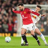 WHY IT MATTERS: Leeds United's Ethan Ampadu battles for the ball with Manchester United's Bruno Fernandes at Old Trafford in April last season. The two rivals meet again on Sunday at Elland Road. Picture: Martin Rickett/PA