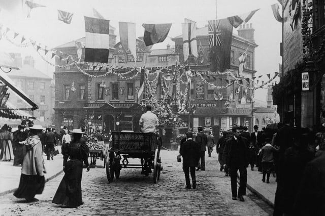 Bunting and flags decorate Sheffield Market Place in 1905.