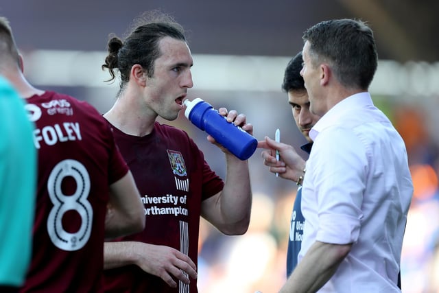 ohn-Joe O'Toole of Northampton Town takes a drink as manager Dean Austin makes a point during the Sky Bet League One match between Northampton Town and Oldham Athletic at Sixfields on May 5, 2018.