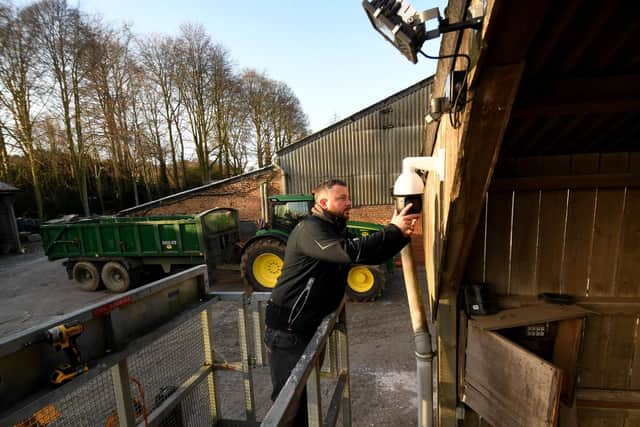 Lee Turner is pictured putting up security cameras at a farm near Hovingham