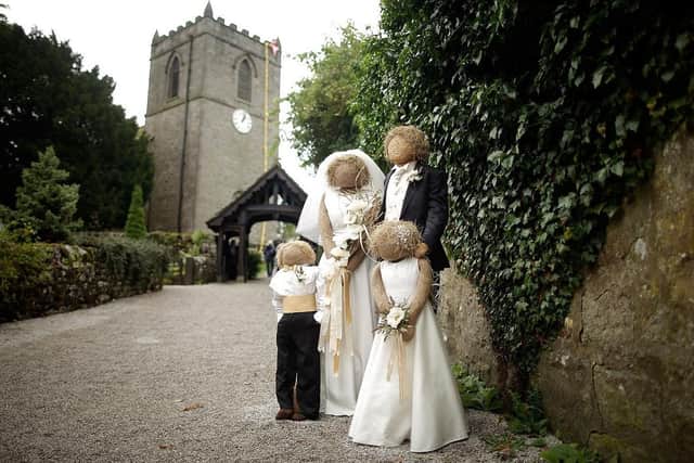 Scarecrows dressed as a bridal party stand as part of the annual scarecrow festival in Kettlewell. (Pic credit: Matthew Lloyd / Getty Images)