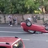 A car dramatically flipped and came to rest on its roof.