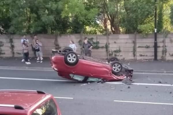 A car dramatically flipped and came to rest on its roof.