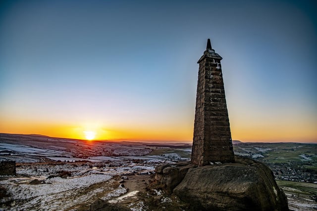 The sun sets on Wainman's Pinnicle on the skyline above Cowling near Keighley in West Yorkshire. Picture Tony Johnson