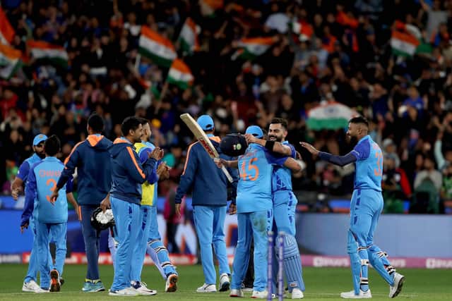 Kohli and his India team-mates celebrate. Photo by Surjeet Yadav/AFP via Getty Images).
