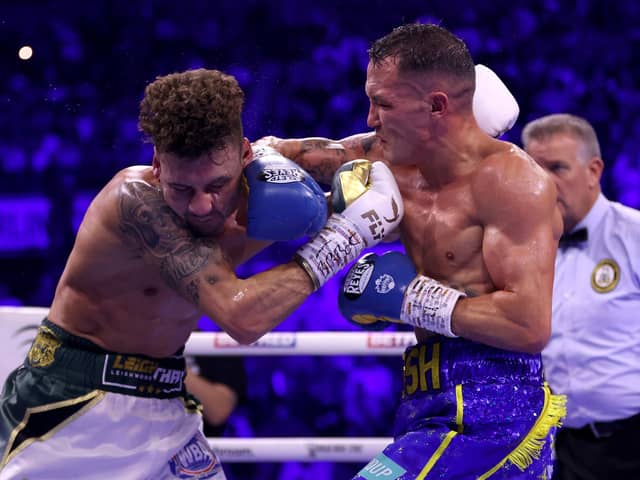 SHEFFIELD, ENGLAND - OCTOBER 07: Leigh Wood exchanges punches with Josh Warrington during the WBA World Featherweight Title fight between Leigh Wood and Josh Warrington at Utilita Arena Sheffield on October 07, 2023 in Sheffield, England. (Photo by James Chance/Getty Images)