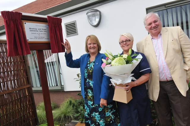 Hugh Morgan-Williams, right, opening a hospital dementia unit during his role as an NHS chairman in 2014