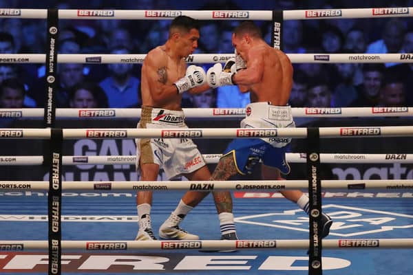 LEEDS, ENGLAND - SEPTEMBER 04: Mauricio Lara and Josh Warrington exchange punches during the Featherweight fight between Mauricio Lara and Josh Warrington at Emerald Headingley Stadium on September 04, 2021 in Leeds, England. (Photo by George Wood/Getty Images)