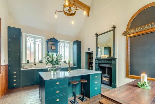 The kitchen with English oak cabinetry and a host of vintage finds, including the chalk board, originally from a Catholic church, and a secret door to the third bedroom