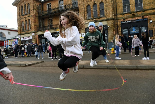 A young girl skipping.