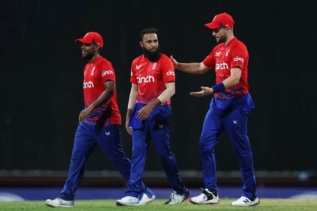 Adil Rashid (C) of England celebrates with teammates Chris Woakes (R) and Rehan Ahmed (L) after getting the wicket of Shimron Hetmyer of West Indies during the 1st T20 International between West Indies and England at Kensington Oval on December 12, 2023 in Bridgetown, Barbados. (Photo by Ashley Allen/Getty Images)