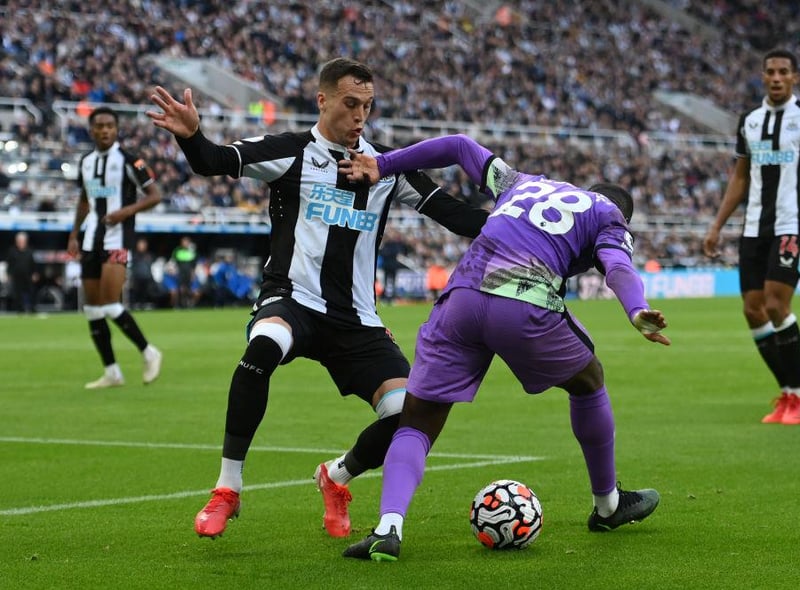 Tanguy Ndombele of Spurs is challenged by Javier Manquillo during the Premier League match between Newcastle United and Tottenham Hotspur at St. James Park on October 17, 2021 in Newcastle upon Tyne, England.