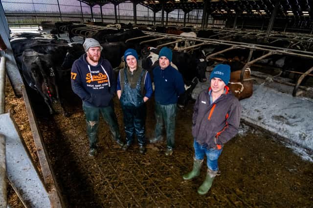Dairy team, Martin, Rosie, and Martin, with dairy and arable framer Joe Dugdale, and some of the dairy herd.