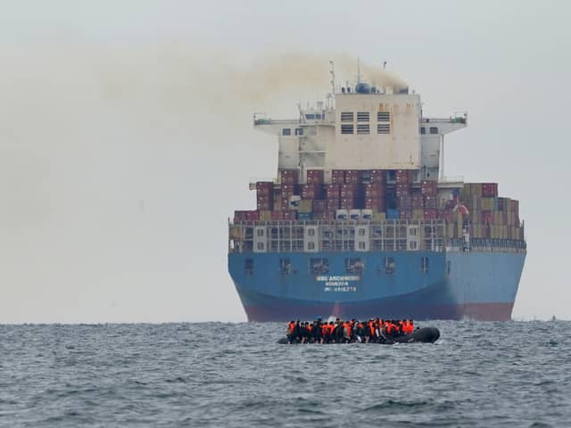 A group of people thought to be migrants crossing the Channel in a small boat traveling from the coast of France and heading in the direction of Dover, Kent. PIC: Gareth Fuller/PA Wire