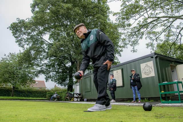 Maurice Holleran, 94 playing for Harehills Crown Green Bowling club in Leeds in a league match with Moor Allerton in the pouring rain, photographed for the Yorkshire Post by Tony Johnson. The club have been providing free sessions and activities to help local people struggling with the cost of living- and have doubled their numbers as a result so they're doing more sessions over the summer.