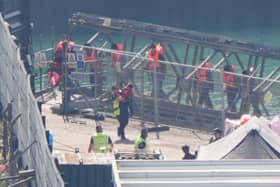 A group of people thought to be migrants are brought in to the Border Force compound in Dover, Kent. PIC: Gareth Fuller/PA Wire
