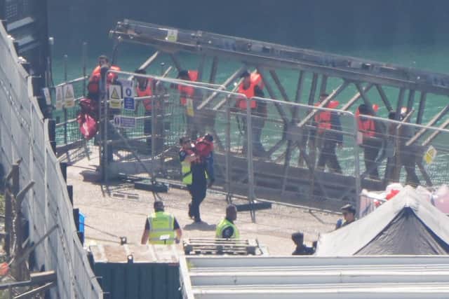 A group of people thought to be migrants are brought in to the Border Force compound in Dover, Kent. PIC: Gareth Fuller/PA Wire