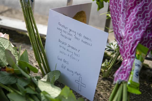 Tributes laid at the scene where a 15 year old boy was stabbed and died of his injuries outside North Huddersfield Trust School on Woodhouse Hill , Fartown in Huddersfield . Picture Tony Johnson