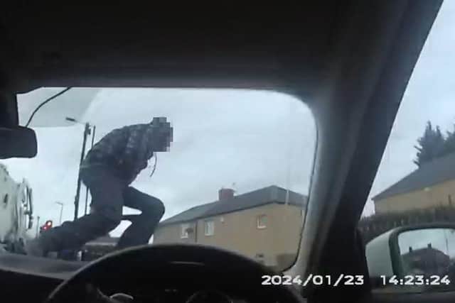 The moment a man jumps over a car bonnet to flee police pursuit.