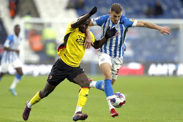 Watford's Ismaila Sarr (left) and Huddersfield Town's Michal Helik battle for the ball during the Sky Bet Championship match at John Smith's Stadium, Huddersfield. Picture: Will Matthews/PA Wire.