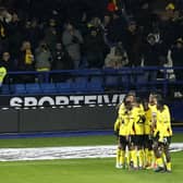 Watford's Jaoa Pedro (hidden) celebrates scoring his side's first goal of the game with team-mates in front of the fans during the Sky Bet Championship match at John Smith's Stadium, Huddersfield. Picture: Will Matthews/PA Wire.